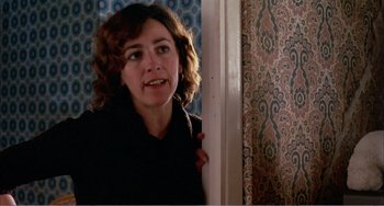 Movie still from “What Have I Done to Deserve This?” (1984), directed by Pedro Almodóvar – A woman leaning against a wall in a room; Close Up shot, Over the shoulder angle