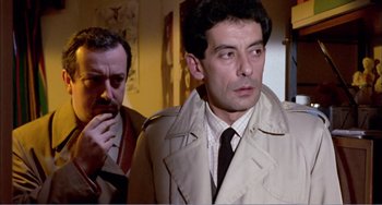Movie still from “What Have I Done to Deserve This?” (1984), directed by Pedro Almodóvar – A man in a trench coat standing next to another man in a tie; Close Up shot, Low angle