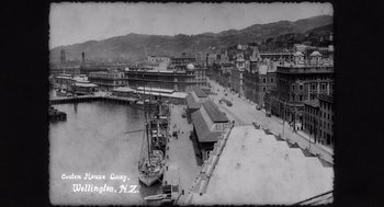 Movie still from “What We Do in the Shadows” (2014), directed by Taika Waititi – An old black and white photo of a harbor; Extreme Wide shot, High angle