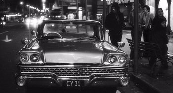 Movie still from “What We Do in the Shadows” (2014), directed by Taika Waititi – An old car parked on the side of the street; Wide shot, Low angle
