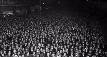 Movie still from “What We Do in the Shadows” (2014), directed by Taika Waititi – A large group of men in suits and hats; Extreme Wide shot, High angle