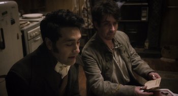 Movie still from “What We Do in the Shadows” (2014), directed by Taika Waititi – Two men sitting next to each other in a room; Medium shot, High angle