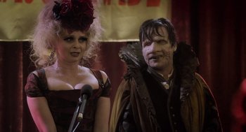 Movie still from “What We Do in the Shadows” (2014), directed by Taika Waititi – A man and a woman dressed up like vampires; Close Up shot, Over the shoulder angle