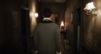 Movie still from “What We Do in the Shadows” (2014), directed by Taika Waititi – A man is walking down the hall way of a house; Medium shot, Low angle