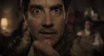 Movie still from “What We Do in the Shadows” (2014), directed by Taika Waititi – A person wearing a fur coat; Close Up shot, Low angle