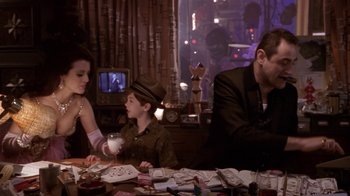 Movie still from “What Women Want” (2000), directed by Nancy Meyers – A man and a woman sitting at a table with a young boy; Medium shot, Over the shoulder angle