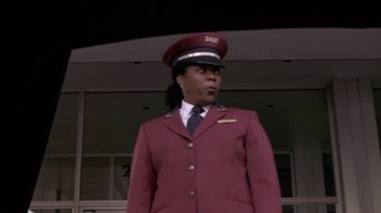 Movie still from “What Women Want” (2000), directed by Nancy Meyers – A woman in a red suit and a red hat; Medium shot, Low angle