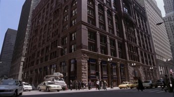 Movie still from “What Women Want” (2000), directed by Nancy Meyers – A group of people walking down a street near tall buildings; Extreme Wide shot, High angle