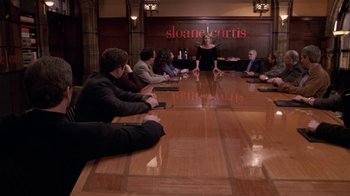 Movie still from “What Women Want” (2000), directed by Nancy Meyers – A group of people sitting around a large wooden table; Wide shot, Over the shoulder angle