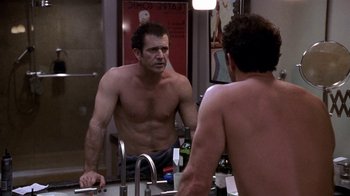 Movie still from “What Women Want” (2000), directed by Nancy Meyers – A man looking at himself in the mirror in a bathroom; Medium shot, Over the shoulder angle