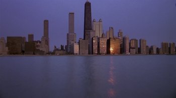 Movie still from “What Women Want” (2000), directed by Nancy Meyers – A view of a city skyline at night time; Extreme Wide shot, High angle