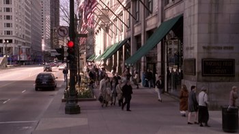 Movie still from “What Women Want” (2000), directed by Nancy Meyers – A group of people walking down a sidewalk near a building; Extreme Wide shot, High angle