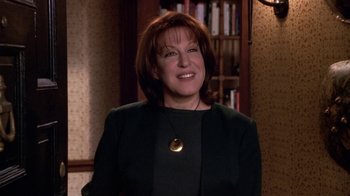 Movie still from “What Women Want” (2000), directed by Nancy Meyers – A woman in a black jacket smiling for the camera; Close Up shot, High angle