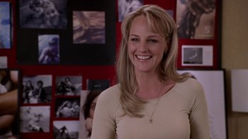 Movie still from “What Women Want” (2000), directed by Nancy Meyers – A woman smiling for the camera in front of pictures; Close Up shot, Over the shoulder angle