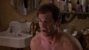 Movie still from “What Women Want” (2000), directed by Nancy Meyers – A shirtless man in a bathroom looking at the camera; Close Up shot, Low angle