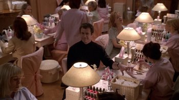 Movie still from “What Women Want” (2000), directed by Nancy Meyers – A group of people sitting around a table with lamps; Medium shot, High angle