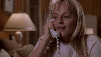 Movie still from “What Women Want” (2000), directed by Nancy Meyers – A woman talking on a phone while sitting in a living room; Close Up shot, High angle