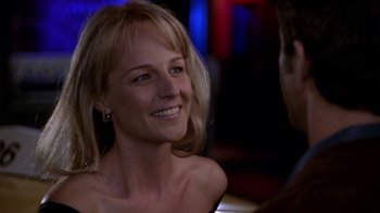 Movie still from “What Women Want” (2000), directed by Nancy Meyers – A woman smiling at the camera while sitting in a bar; Close Up shot, Over the shoulder angle