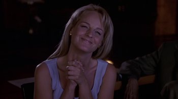 Movie still from “What Women Want” (2000), directed by Nancy Meyers – A beautiful blonde woman smiling with her hands clasped; Close Up shot, Over the shoulder angle