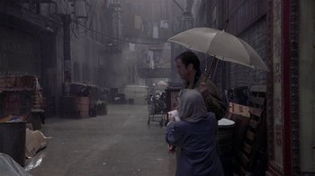 Movie still from “What Women Want” (2000), directed by Nancy Meyers – A man holding an umbrella while standing next to a woman; Wide shot, High angle