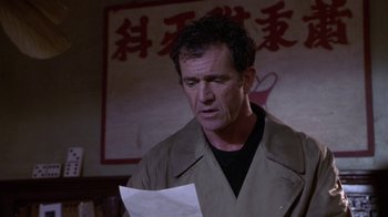 Movie still from “What Women Want” (2000), directed by Nancy Meyers – A man in a brown jacket holding a piece of paper in his hands; Close Up shot, Low angle