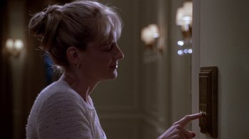 Movie still from “What Women Want” (2000), directed by Nancy Meyers – A woman looking at her cell phone while sitting in a room; Close Up shot, Over the shoulder angle