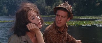 Movie still from “What a Way to Go!” (1964), directed by J. Lee Thompson – A man and a woman sitting next to each other; Close Up shot, Over the shoulder angle