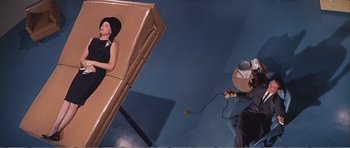 Movie still from “What a Way to Go!” (1964), directed by J. Lee Thompson – A woman in a black dress and a man in a cowboy hat; Wide shot, Overhead angle