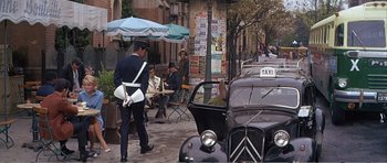 Movie still from “What a Way to Go!” (1964), directed by J. Lee Thompson – A man walking down the street in a city; Wide shot, High angle