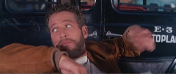 Movie still from “What a Way to Go!” (1964), directed by J. Lee Thompson – A man with a beard is holding a wooden stick; Close Up shot, Low angle