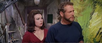 Movie still from “What a Way to Go!” (1964), directed by J. Lee Thompson – A man and a woman standing next to each other; Close Up shot, Low angle