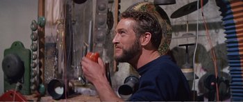 Movie still from “What a Way to Go!” (1964), directed by J. Lee Thompson – A man holding a tomato in his hand; Close Up shot, Over the shoulder angle