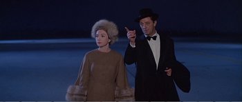 Movie still from “What a Way to Go!” (1964), directed by J. Lee Thompson – A man and a woman standing next to each other; Medium shot, Low angle