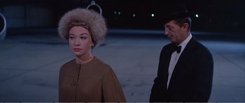 Movie still from “What a Way to Go!” (1964), directed by J. Lee Thompson – A man and a woman standing next to each other; Close Up shot, Over the shoulder angle