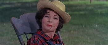 Movie still from “What a Way to Go!” (1964), directed by J. Lee Thompson – A person wearing a straw hat; Close Up shot, Low angle