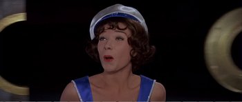 Movie still from “What a Way to Go!” (1964), directed by J. Lee Thompson – A person wearing a hat; Close Up shot, Low angle