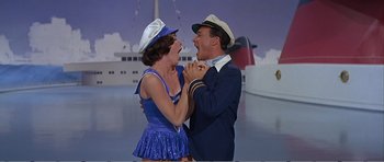 Movie still from “What a Way to Go!” (1964), directed by J. Lee Thompson – A man and a woman dressed in sailor outfits; Medium shot, Low angle