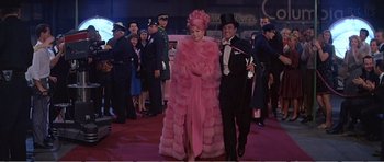 Movie still from “What a Way to Go!” (1964), directed by J. Lee Thompson – A man and a woman dressed up in costumes; Wide shot, High angle
