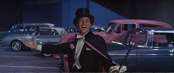 Movie still from “What a Way to Go!” (1964), directed by J. Lee Thompson – A man wearing a top hat and a tuxedo; Medium shot, Low angle