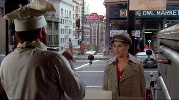 Movie still from “What's Up, Doc?” (1972), directed by Peter Bogdanovich – A woman is standing on the side of the street; Medium shot, Over the shoulder angle