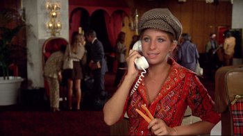 Movie still from “What's Up, Doc?” (1972), directed by Peter Bogdanovich – A woman in a hat is talking on a phone; Medium shot, High angle