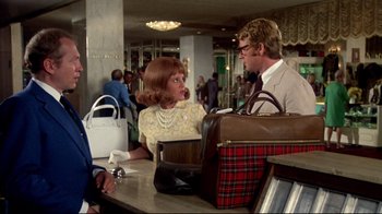 Movie still from “What's Up, Doc?” (1972), directed by Peter Bogdanovich – A woman sitting at a counter talking to a man; Medium shot, Over the shoulder angle