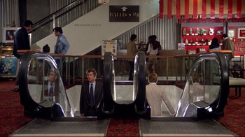 Movie still from “What's Up, Doc?” (1972), directed by Peter Bogdanovich – A group of people standing in a building; Wide shot, High angle