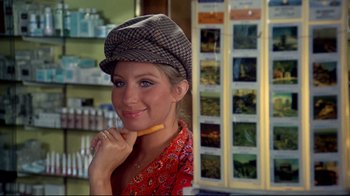 Movie still from “What's Up, Doc?” (1972), directed by Peter Bogdanovich – A woman in a hat is holding a pencil in her mouth; Close Up shot, Over the shoulder angle