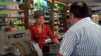 Movie still from “What's Up, Doc?” (1972), directed by Peter Bogdanovich – A woman is talking to a man in a store; Medium shot, Over the shoulder angle