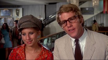 Movie still from “What's Up, Doc?” (1972), directed by Peter Bogdanovich – A man and a woman standing next to each other; Close Up shot, High angle