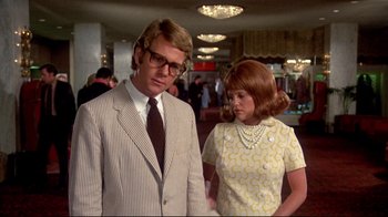 Movie still from “What's Up, Doc?” (1972), directed by Peter Bogdanovich – A man and a woman standing next to each other; Medium shot, Low angle