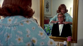 Movie still from “What's Up, Doc?” (1972), directed by Peter Bogdanovich – A woman is looking at a man in the mirror; Medium shot, Over the shoulder angle