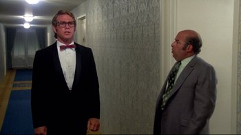 Movie still from “What's Up, Doc?” (1972), directed by Peter Bogdanovich – A man in a suit and tie standing next to another man in a suit and tie; Medium shot, Low angle