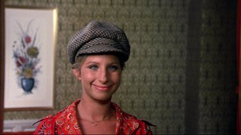 Movie still from “What's Up, Doc?” (1972), directed by Peter Bogdanovich – A young woman wearing a hat and a red shirt; Close Up shot, High angle